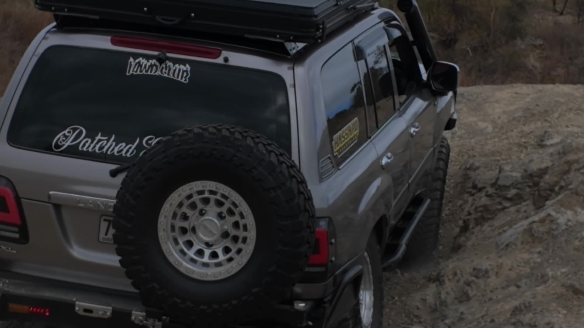 An i4wd.club LandCruiser crawling a rocky track and running across the flats